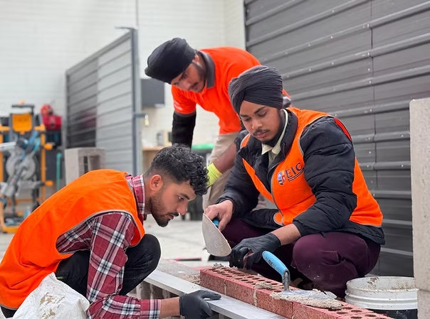 Vocational learners practising construction skills in an Australian training workshop